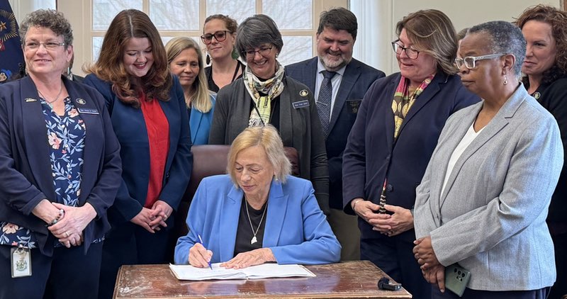 Governor Mills signing LD 1 into law