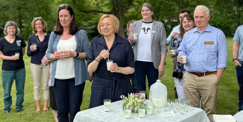 Governor Mills and a group of people doing a milk toast