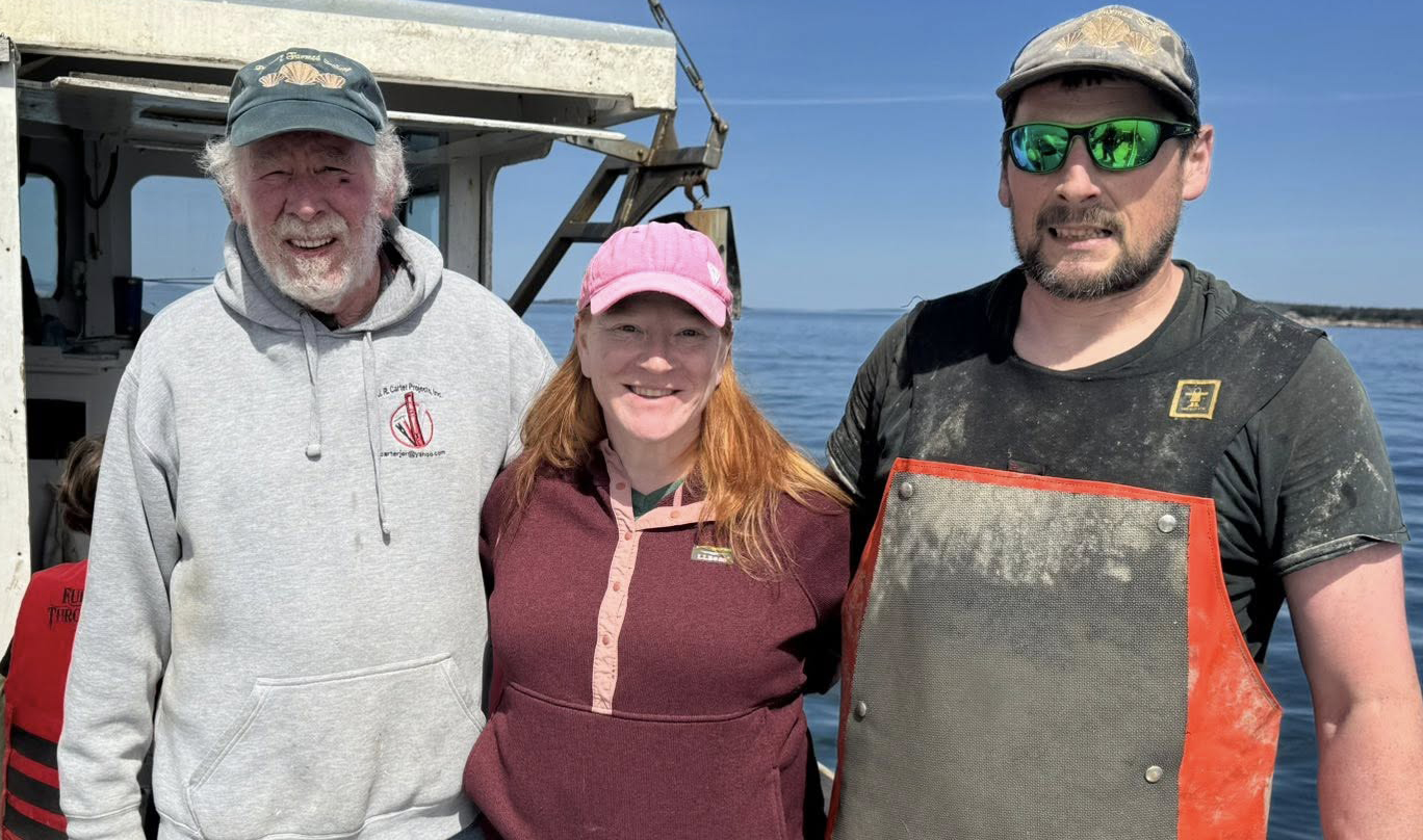 Rep. Holly Eaton joins Marsden Brewer (left) and Bobby Brewer (right) to explore their farm-grown scallops at PenBay Farmed Scallops in April earlier this year.