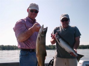 Successful anglers on Sebago show a lake trout (left) and landlocked salmon (right). These two species often compete for food in Maine waters. (Photo courtesy: Greg Massey)