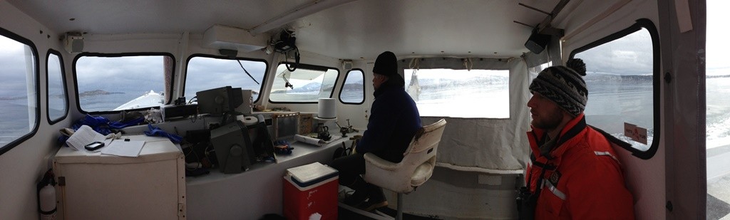 The enclosed cabin of the lobster boat provides a brief respite from the elements.