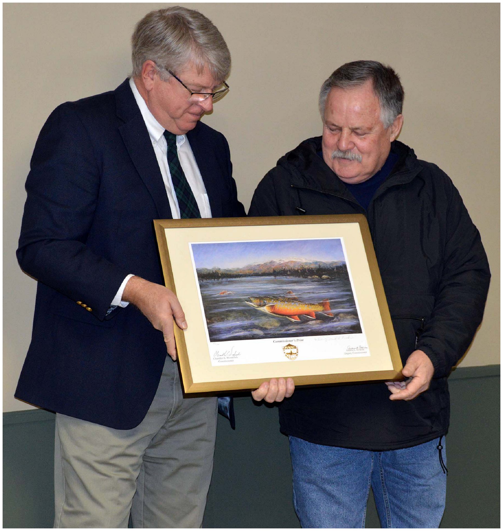 Commissioner Woodcock (left) presents a Commissioner's Print to Butch Vickerson (right)