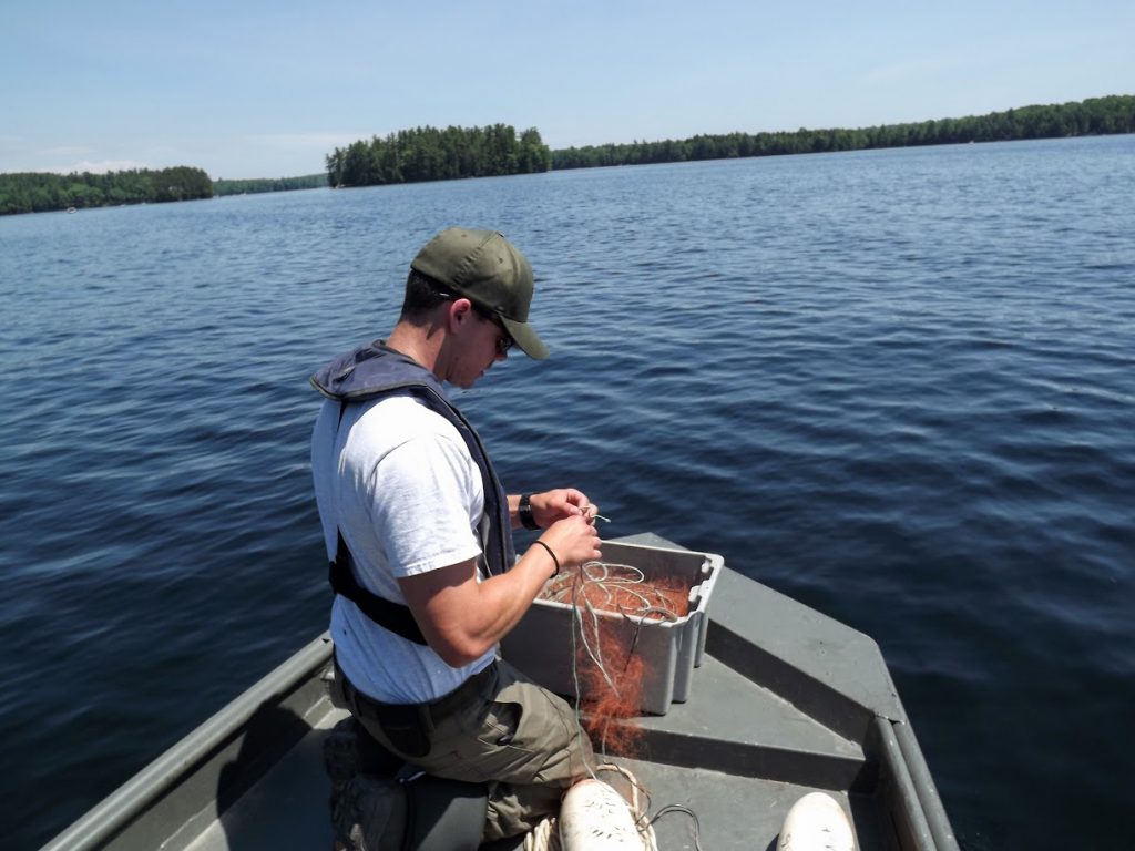 Camden Marshall prepares to set the net. The net remains in the water overnight, and is retrieved the next morning.