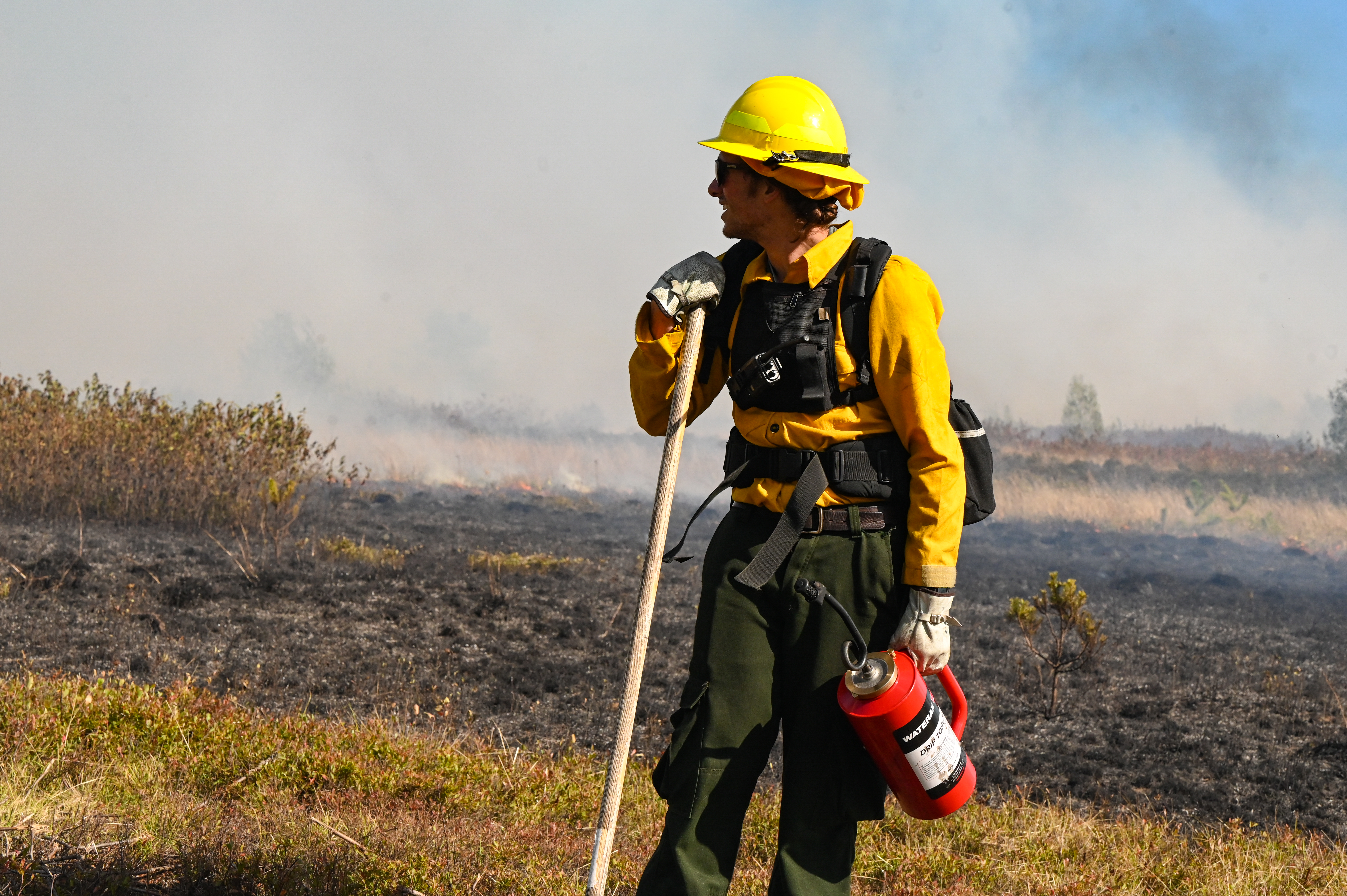 burn crew member with drip torch