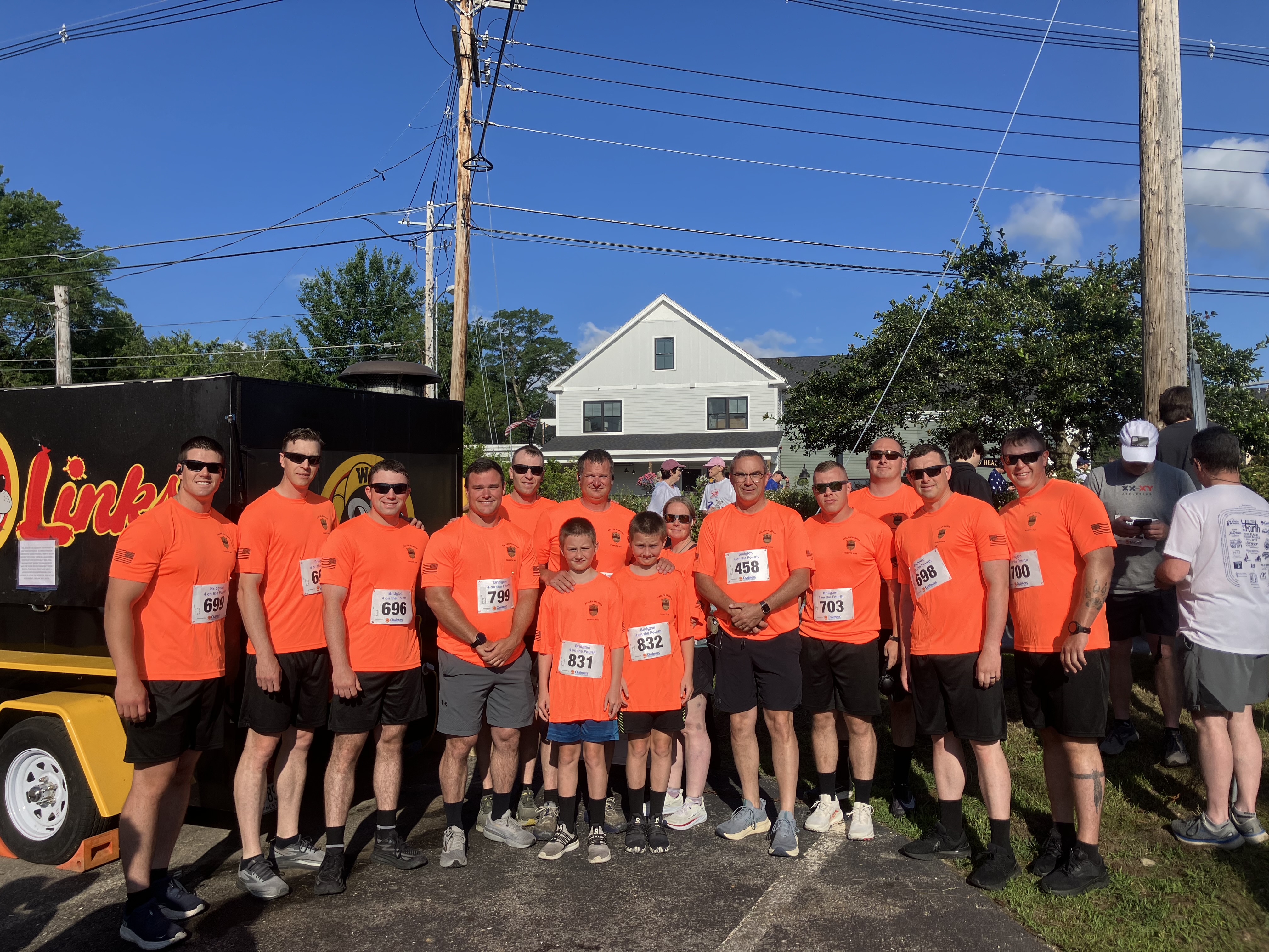 Group of wardens standing for group photo after road race