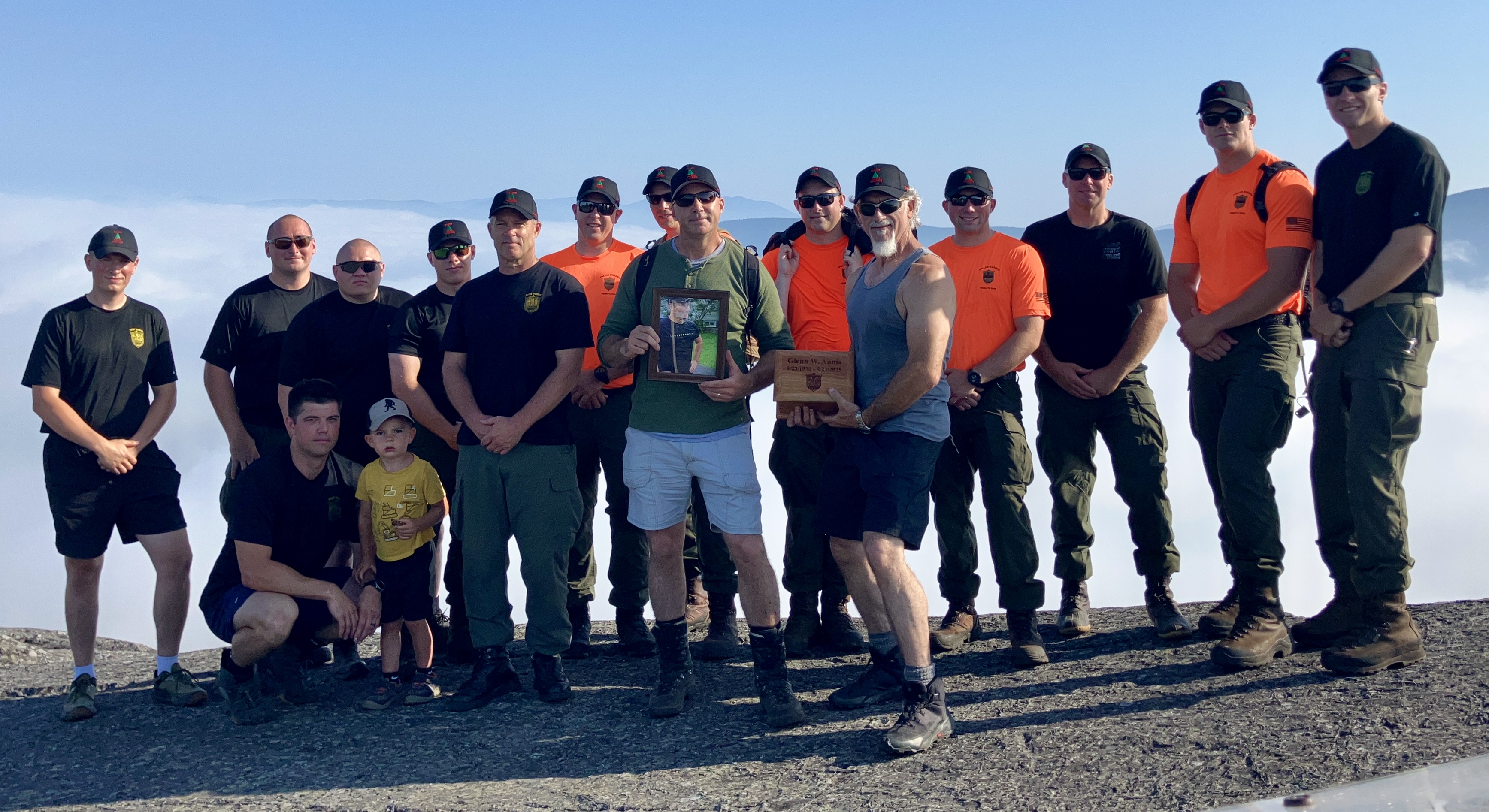 Group of wardens and family members at the top of a mountain