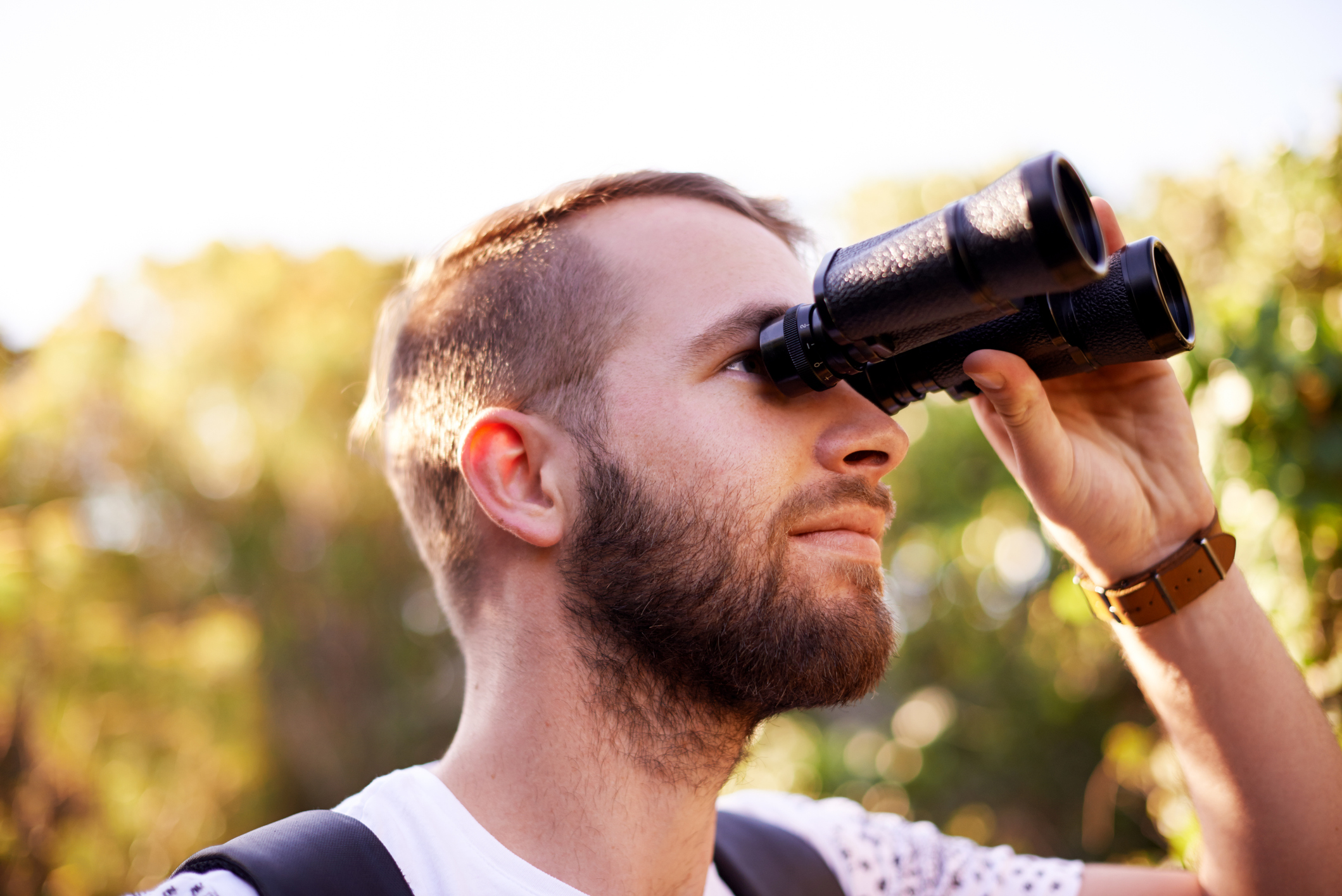 person looking through binoculars