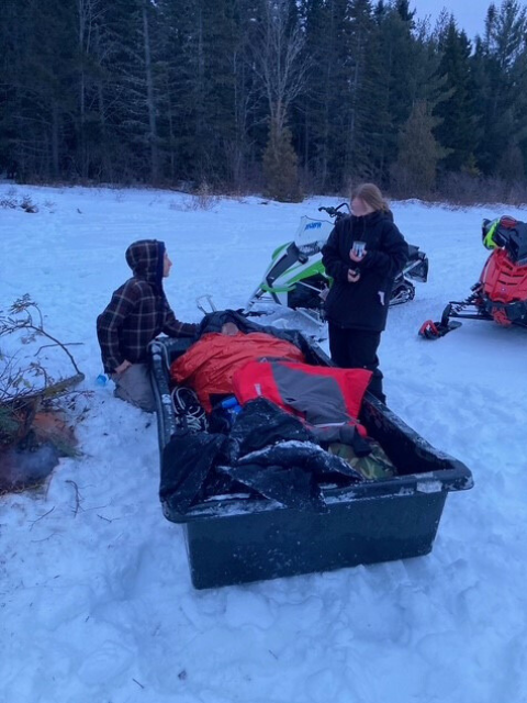 man in rescue sled after falling through ice