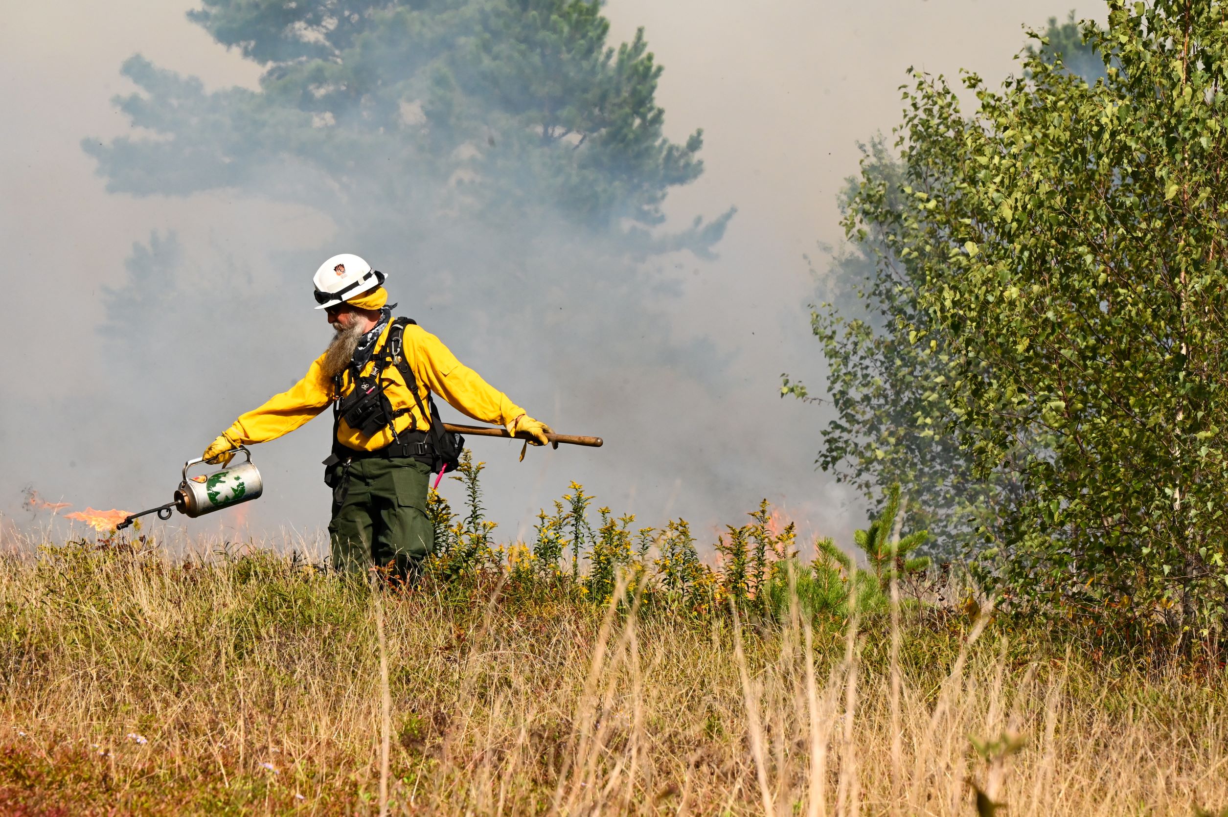 crew member using drip torch