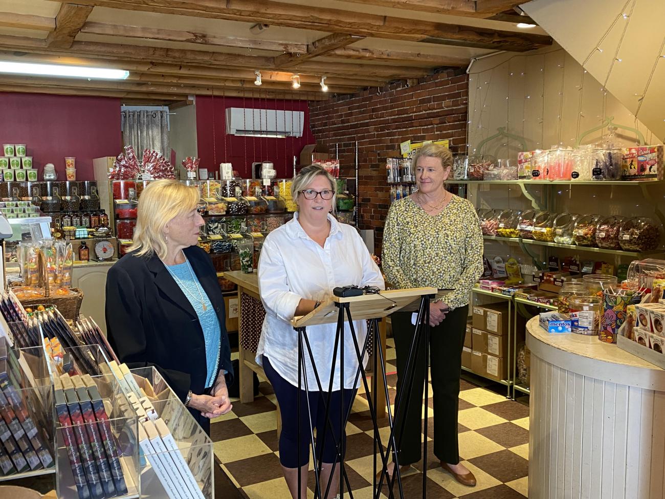 Gov. Mills, Old Port Candy Co-Owner Anna Largay, and Health and Human Services Commissioner Jeanne Lambrew