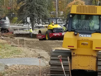 Excavating the roadway and placing gravel near the park at West Road