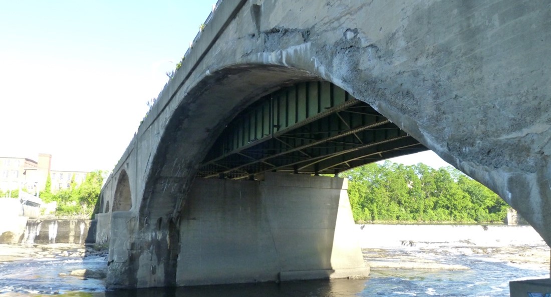 River view of deterioration on arches of bridge