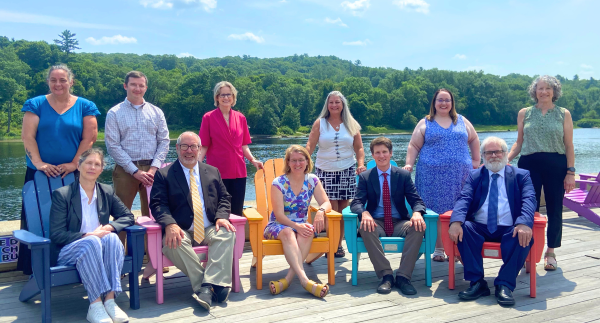 Group photo of OPA staff in front of the Kennebec River