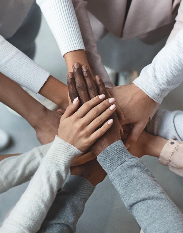 Stock photo of overlapping hands, many skin tones