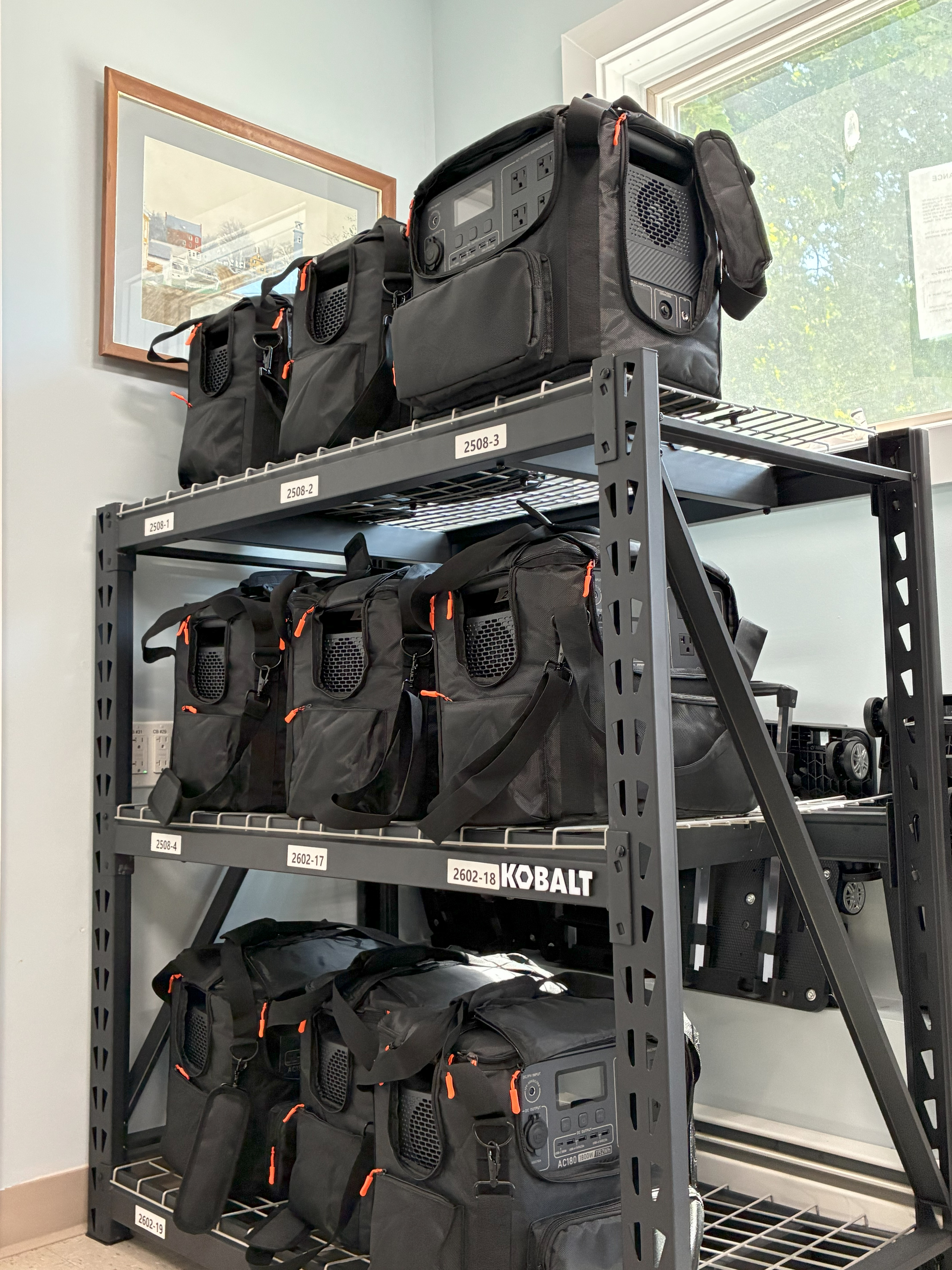 A rack with a stack of black bags in a town office.