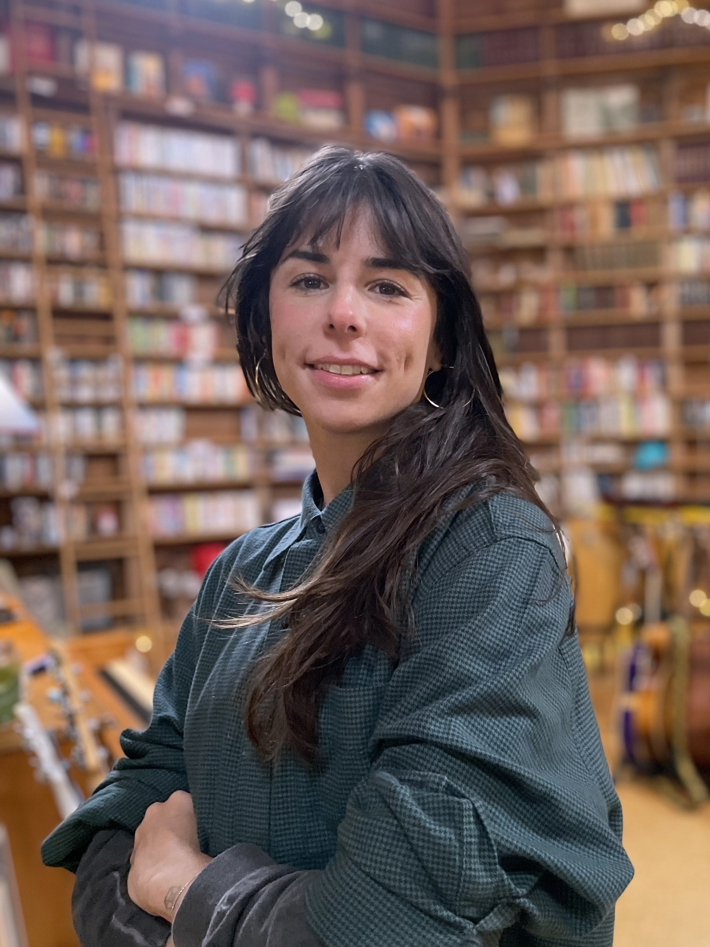 Portrait of a woman in a bookstore.