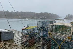 Lobster traps on a foggy harbor.