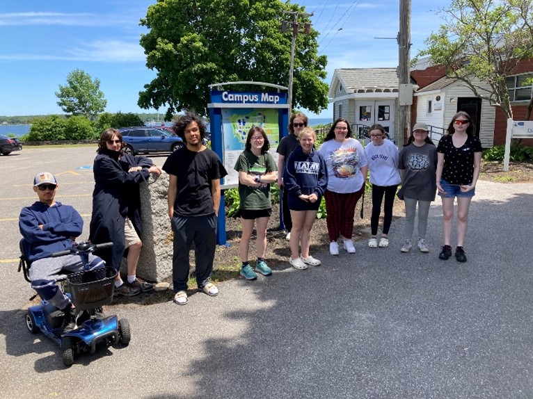 This is a picture of students infront of a campus map kiosk.