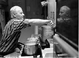 Image of Business Enterprise Facility manager preparing soup for the lunch time crowd.