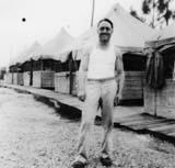 Wallace M. Thompson in front of tents