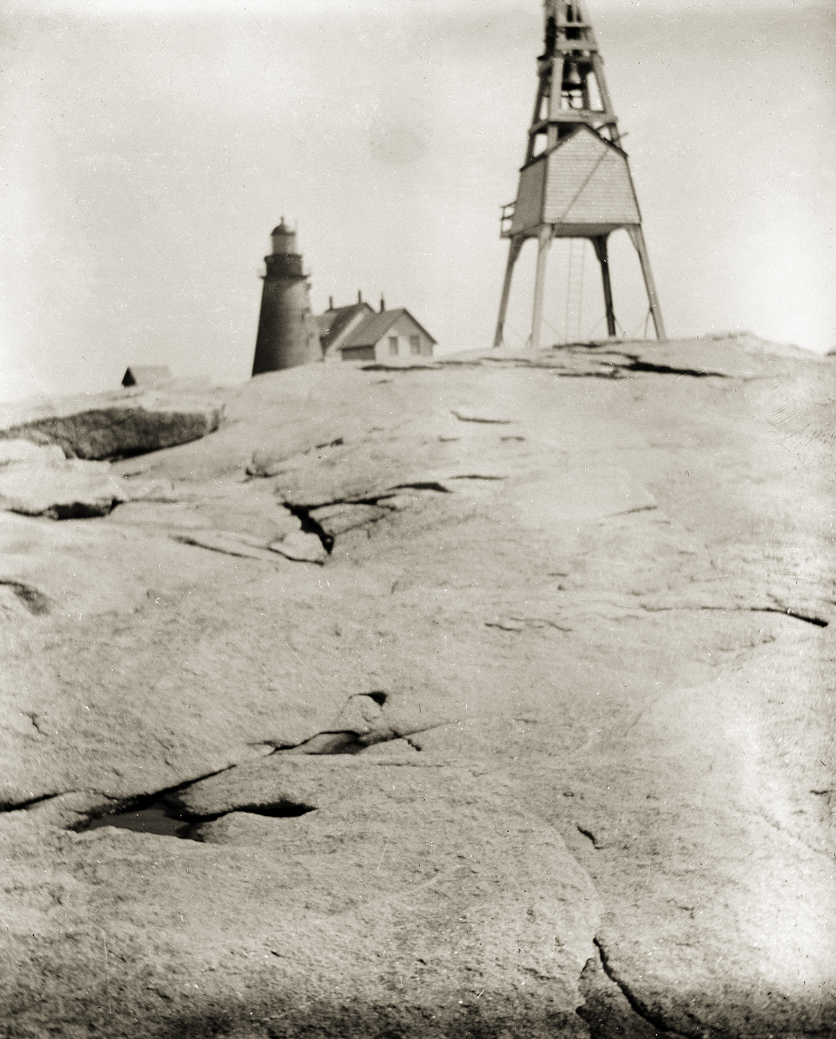 Rocky island with watchtower and lighthouse in background