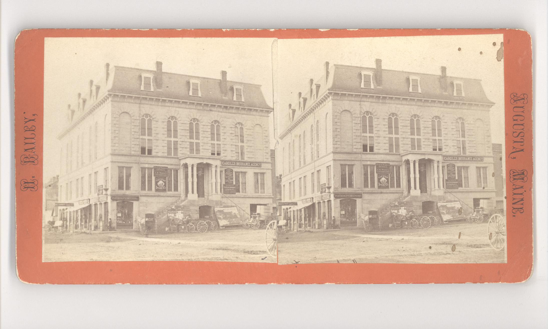 A historical stereograph of Granite Hall in Augusta, Maine, a three-story stone building with arched windows and storefronts on the ground level.