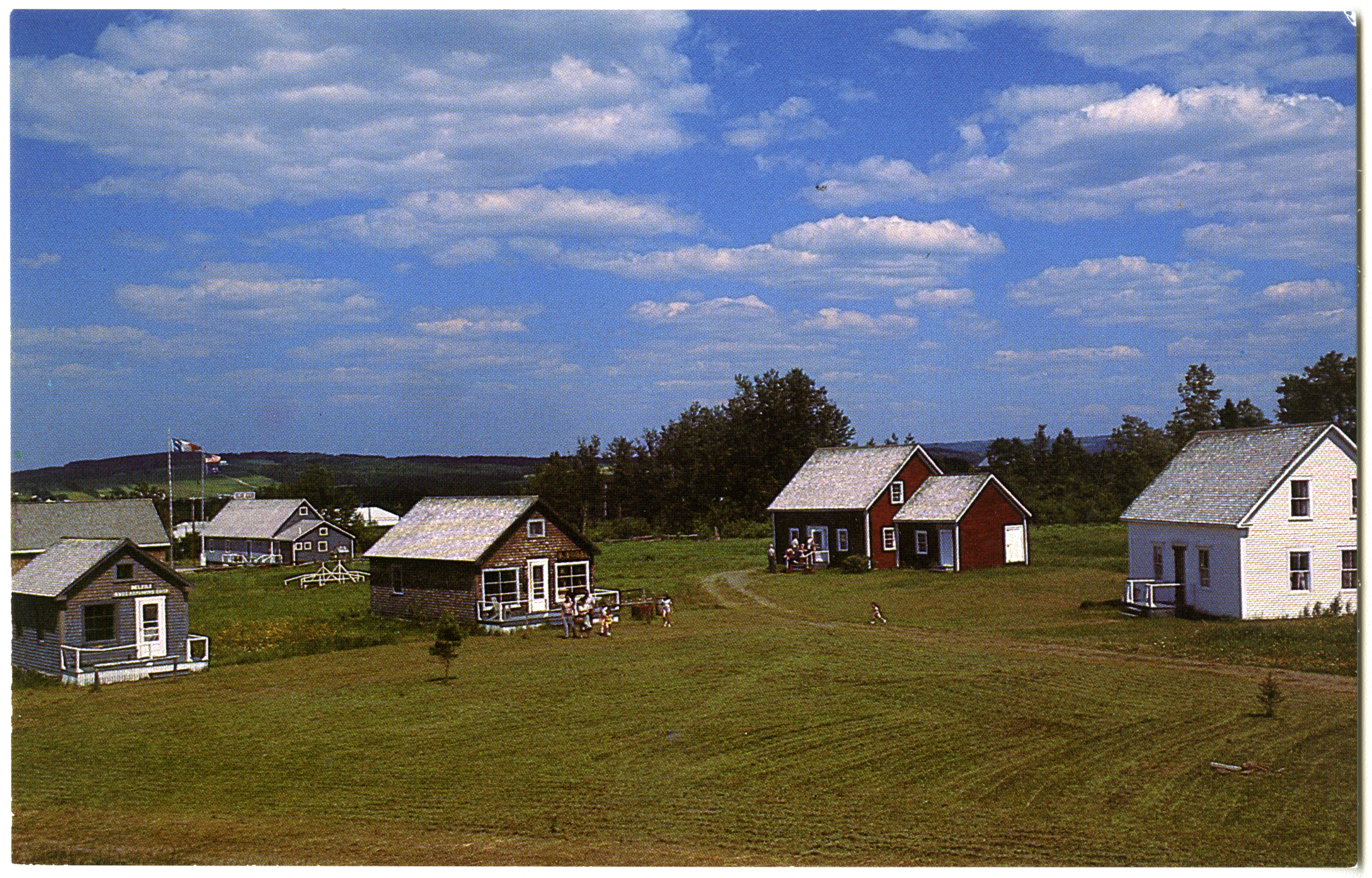 Four cabins in an old village on lush greenery