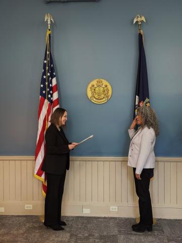 Secretary Bellows swears in Lelia De Andrade in front of US and Maine flags