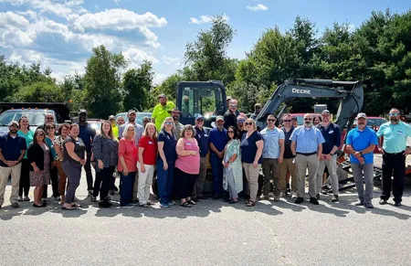 MBVS Employees in front of an excavator